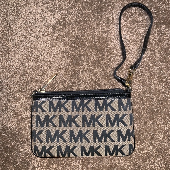 Michael Kors Handbags - Tan and black monogrammed MK wristlet.